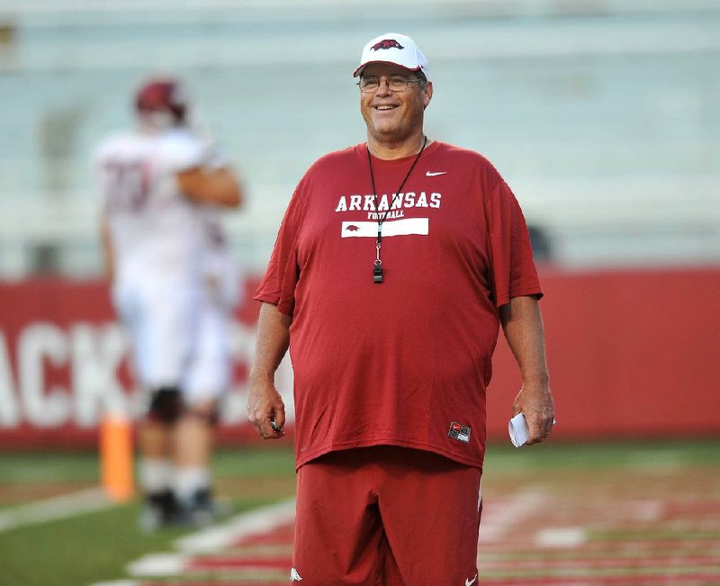 Former University of Arkansas coach Jim Chaney watches the Razorbacks run drills during practice in this file photo.