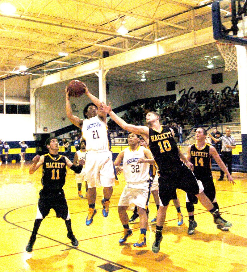 Photo by Mike Eckels Decatur Bulldog Pheng Lee (#21) penetrates the lane for a jumper during the Jan. 9 match up with the Hackett Hornets at the Dawg Pound at Decatur High School. Decatur took the win, 54 to 17, making it conference win number four.