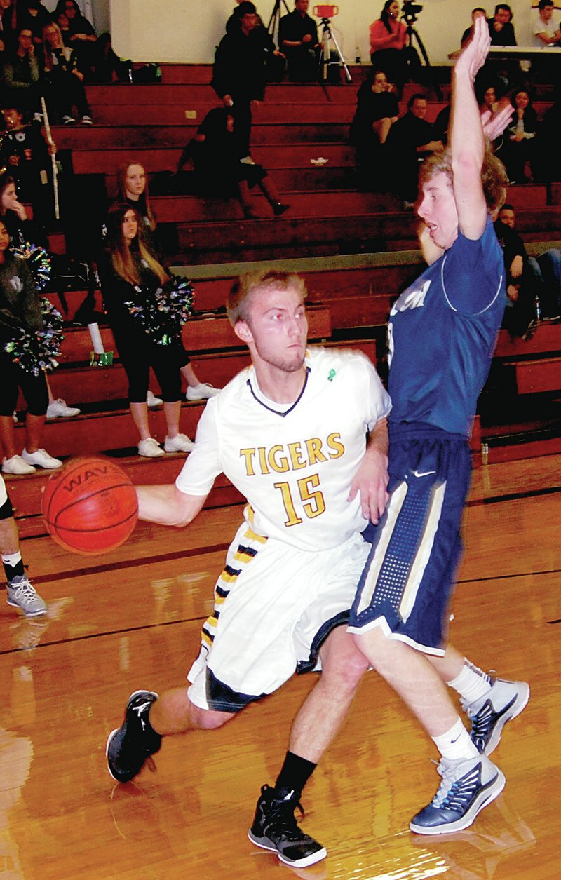 BEN MADRID ENTERPRISE-LEADER Prairie Grove senior Leighton Smith passes around a Shiloh Christian defender on the baseline. Prairie Grove defeated the Saints 51-40 in 4A-1 boys basketball action on Jan. 6.