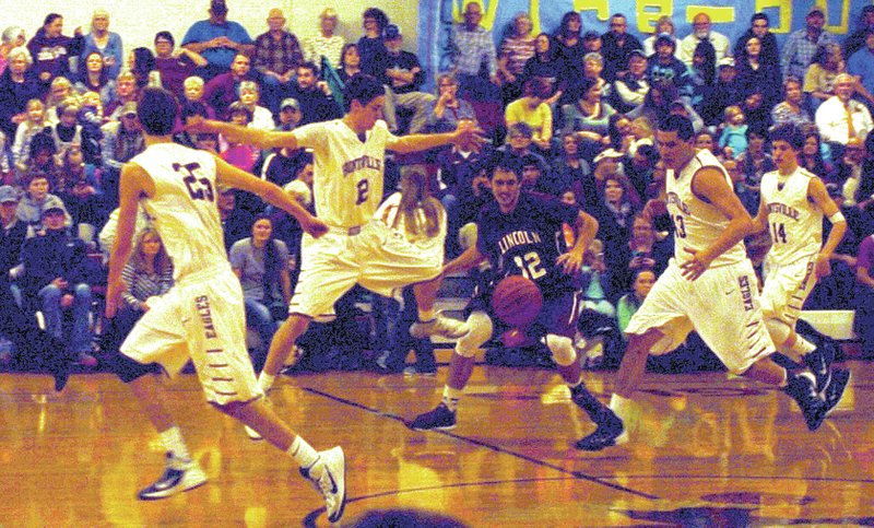 MARK HUMPHREY ENTERPRISE-LEADER Lincoln senior Garrett Blankenship finds himself surrounded by opponents while trying to corral a loose ball during Friday&#8217;s boys basketball contest at Huntsville. Lincoln lost 62-40 after beating Berryville, 50-36, on Jan. 6 to split their games during the week.