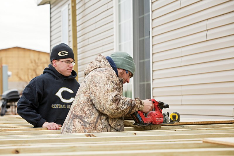 Hendrix student Michael McMurray, 20, of Little Rock, left, and University of Central Arkansas student Eamonn Mayo, 19, of Conway work last week to build a porch at a home in Mayflower that was damaged by the area’s April tornado. They were among 60 students from throughout the state who participated in the annual mission trip through the Ozark Mission Project.