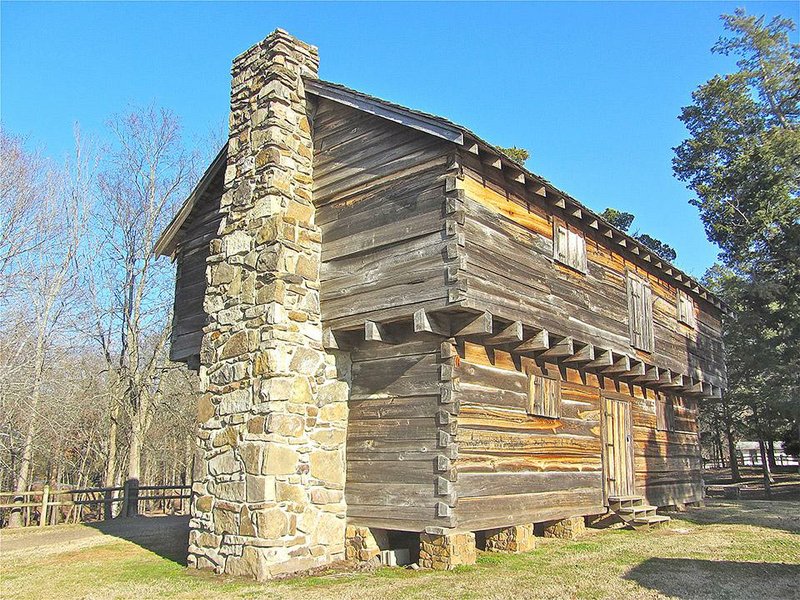 A replica of the pioneer-era blockhouse that stood at Cadron two centuries ago overlooks the Arkansas River in Faulkner County.