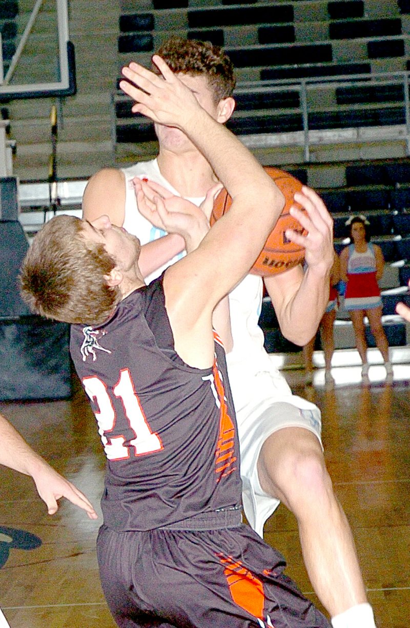 RICK PECK MCDONALD COUNTY PRESS McDonald County&#8217;s Kole Keith attempts to draw a charge on Webb City&#8217;s Tate Smith during the Mustangs 41-39 win Saturday in the seventh place game of the Kaminsky Classic at Joplin High School.