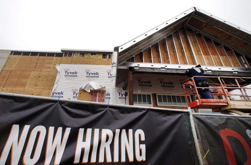 In this Jan. 12, 2015 photo, construction continues on a commercial property in Peabody, Mass.  The Federal Reserve releases its latest Beige Book survey of economic conditions on Wednesday, Jan. 14, 2015.