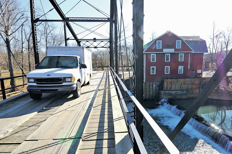 NWA Democrat-Gazette/ J.T. WAMPLER A truck crosses the War Eagle Bridge on Wednesday. Benton County Judge Bob Clinard and the county Road Department staff met with state Highway Department officials, engineers and contractors Wednesday to discuss repair work needed on bridge.