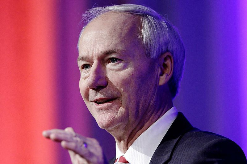 Gov. Asa Hutchinson addresses the Arkansas Municipal League on Thursday in Little Rock and touted his plan to cut income taxes for middle-class taxpayers. Hutchinson later traveled to Washington to meet with federal officials about the private option.