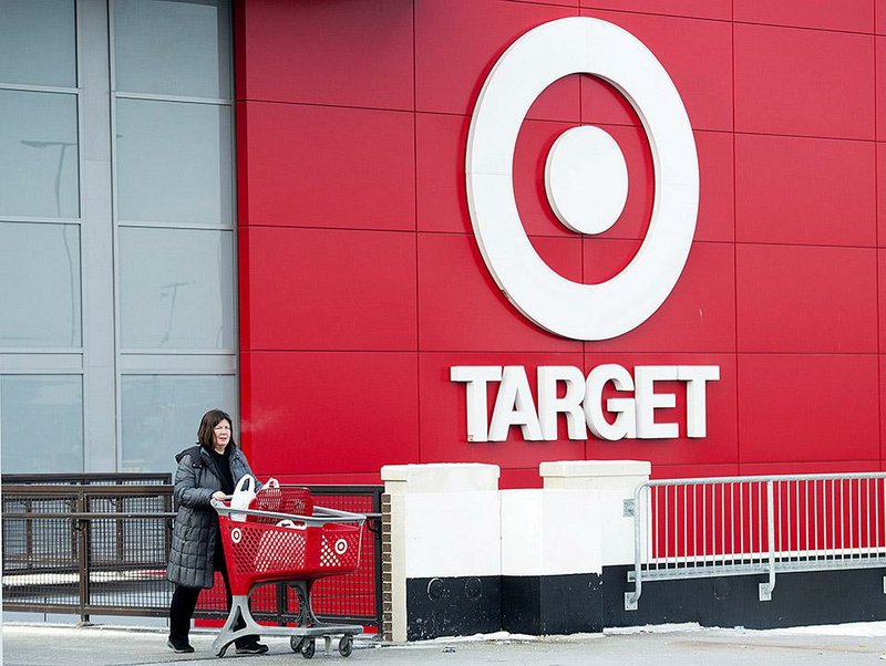 A shopper exits a Target store in Toronto on Thursday. The Minneapolis-based retailer says it plans to close all of its 133 stores in Canada.