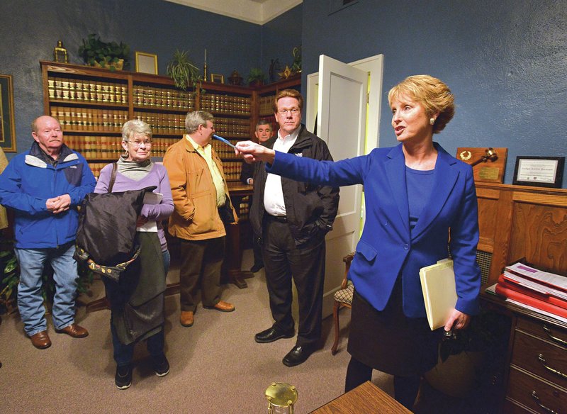 NWA Democrat-Gazette/BEN GOFF Xollie Duncan, right, Benton County circuit judge, leads a tour Thursday through her office in the Benton County Courthouse in Bentonville for justices of the peace. The tour was an opportunity for the Quorum Court member to appraise the state of the courthouse and two annex buildings as they weigh decisions regarding the construction of a replacement facility.