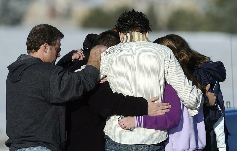 People comfort one another after a 2007 shooting at New Life Church in Colorado Springs, Colo. that killed two.