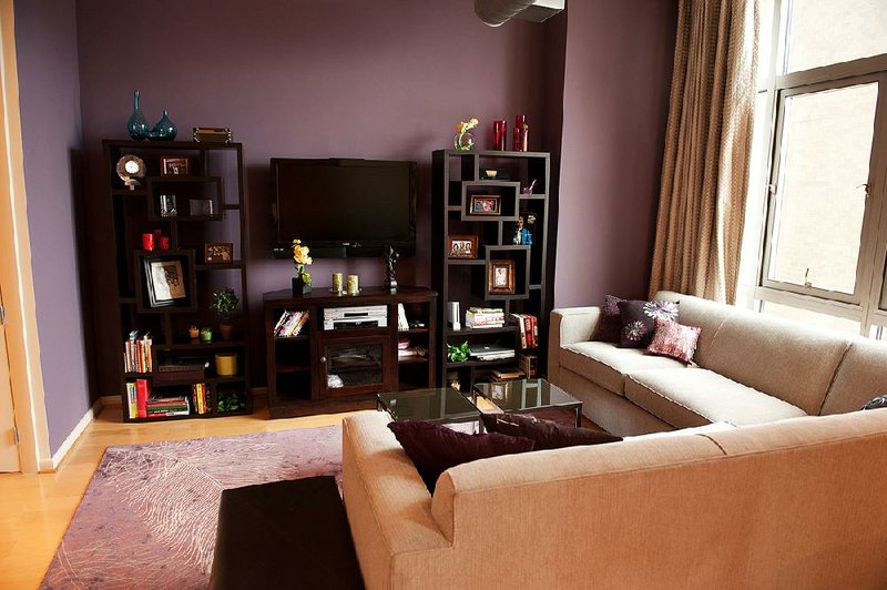 Designer Ebonee Bachman carried violet, the color of the living room accent wall, throughout this one-bedroom loft. Bachman says using too many colors makes a small space appear cramped. 