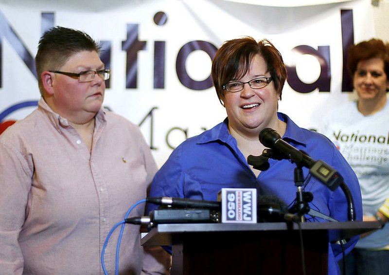 Jayne Rowse (left) and her domestic partner, April DeBoer, hold a news conference Friday in Ferndale, Mich., after the U.S. Supreme Court announced it would review a ruling that upheld bans on same-sex marriages in four states. “We are now that much closer to being fully recognized as a family, and we are thrilled,” DeBoer, a hospital nurse, said.