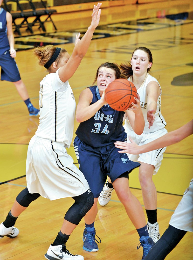 NWA Democrat-Gazette/BEN GOFF Caroline Hornor of Springdale Har-Ber shoots as Peyton Taylor, left, and Maren Johnston of Bentonville defend Friday at Tiger Arena in Bentonville.