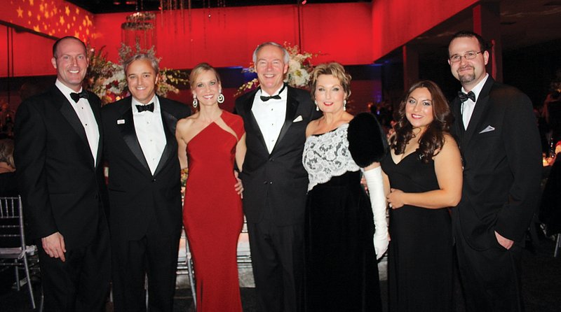 Asa Hutchinson III, from left, Dave and Sarah Wengel, Gov. Asa Hutchinson and wife Susan and Nubia and John Hutchinson stand for a photo at “A New Day in Arkansas” Inaugural Ball on Tuesday evening at the Statehouse Convention Center in Little Rock.