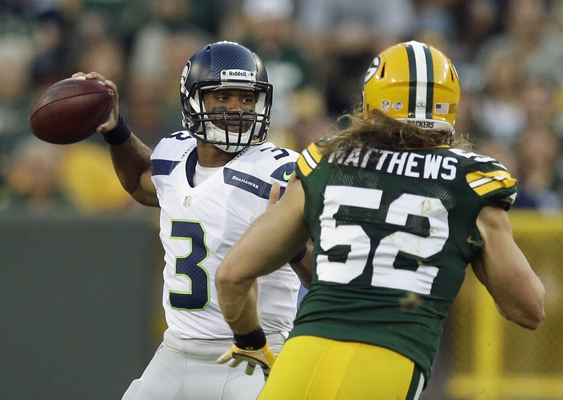 Green Bay Packers fullback John Kuhn (30) (top) is hit by New York