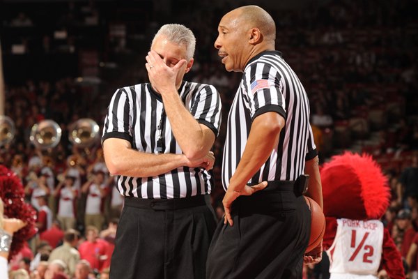 Game officials confer during the second half of play between Arkansas and Mississippi Saturday, Jan. 17, 2015, in Bud Walton Arena in Fayetteville.