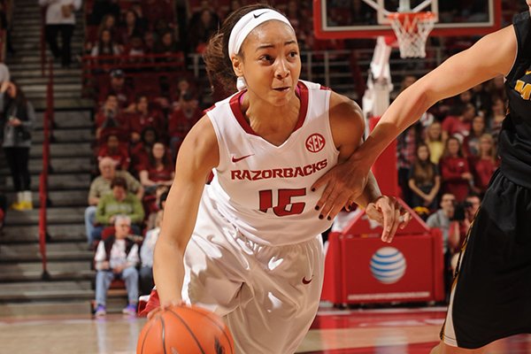 Kelsey Brooks (15) of Arkansas drives past Lindsey Cunningham (11) of Missouri during the first half Saturday, Jan. 17, 2015, in Bud Walton Arena in Fayetteville.