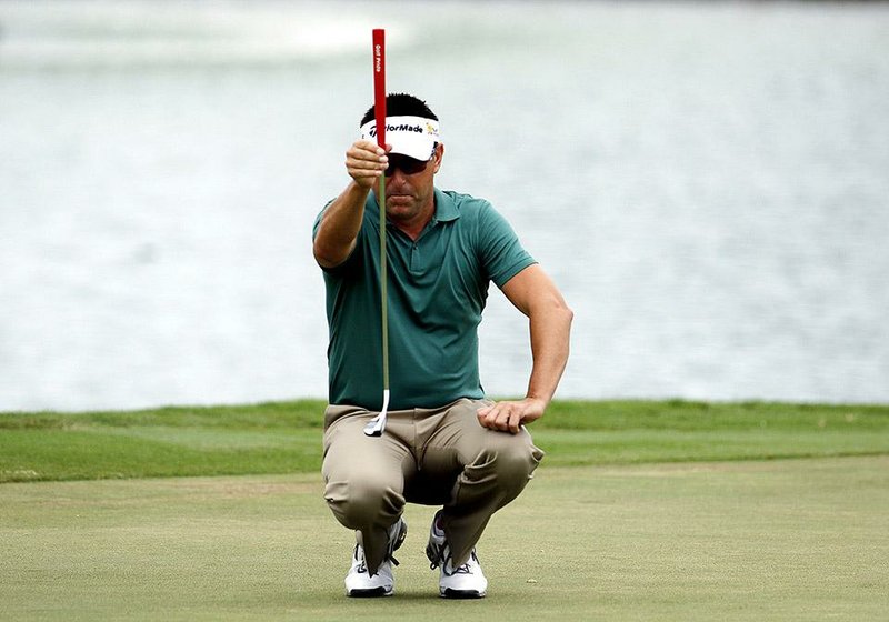Robert Allenby, of Australia, lines up his ball on the third green during the second round of the Sony Open golf tournament, Friday, Jan, 16, 2015, in Honolulu. (AP Photo/Hugh Gentry)