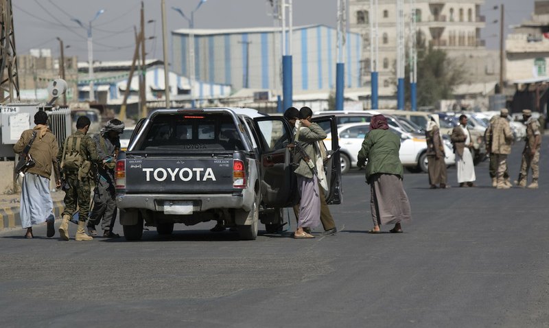 Houthi Shiite Yemenis check a car as they guard a street during clashes near the presidential palace in Sanaa, Yemen, Monday, Jan. 19, 2015. Rebel Shiite Houthis battled soldiers near Yemen's presidential palace and elsewhere across the capital Monday, despite a claim of a cease-fire being reached to halt the violence, witnesses and officials said.
