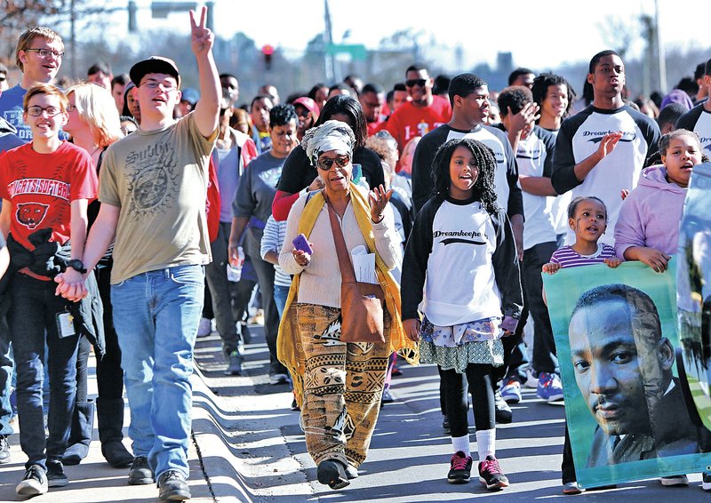 NWA Democrat-Gazette/DAVID GOTTSCHALK Marchers sing and chant Monday while walking up Maple Street during the annual Martin Luther King Jr. March sponsored by Northwest Arkansas Martin Luther King Jr. Council in Fayetteville. The march ended on the University of Arkansas campus where State Rep. Eddie Armstrong, D-North Little Rock, was the keynote speaker.