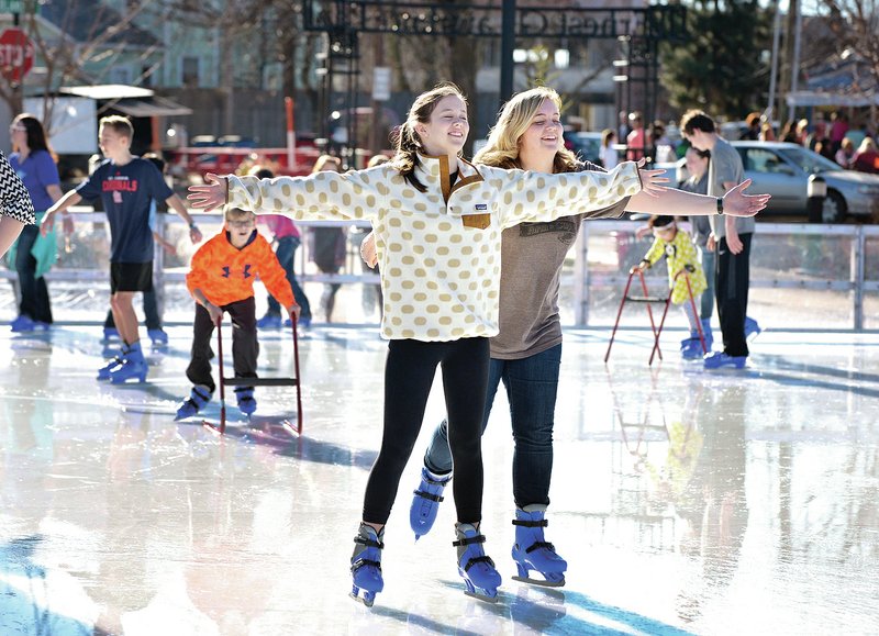 NWA Democrat-Gazette/BEN GOFF Maggie Johnson, 14, left, and sister Leea Johnson of Bentonville skate Monday at The Rink at Lawrence Plaza in Bentonville. Monday is the final day of the season for The Rink.