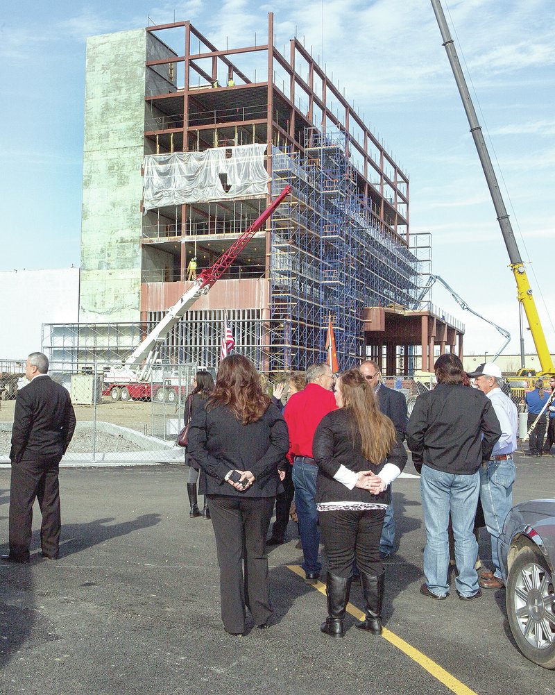 Special to NWA Democrat-Gazette/COREY S. KRASKO Cherokee Nation leaders and local dignitaries gather Monday for a topping out ceremony for the Cherokee Casino and Hotel in Roland, Okla. The $80 million complex includes a six-story, 120-room hotel and a casino with 850 electronic games as well as table games. The project is expected to be completed in the summer.