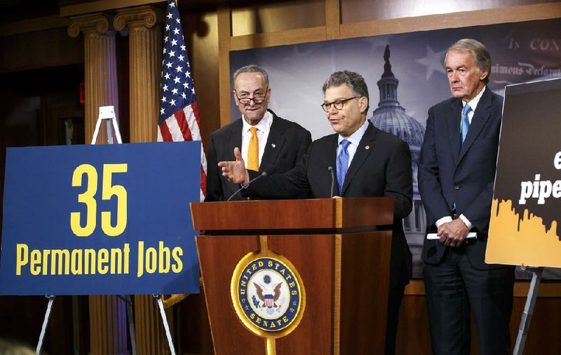 Sen. Al Franken, flanked by fellow Democratic Sens. Charles Schumer (left) and Edward Markey, addresses a news conference about the Keystone XL pipeline bill Tuesday on Capitol Hill in Washington. 