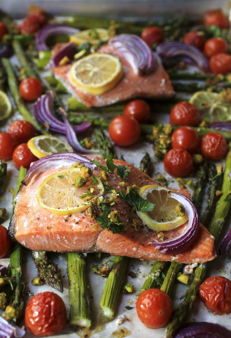 Roasted Fish and Asparagus With Pistachio Gremolata is prepared in a sheet pan lined with parchment paper, making cleanup a breeze. 