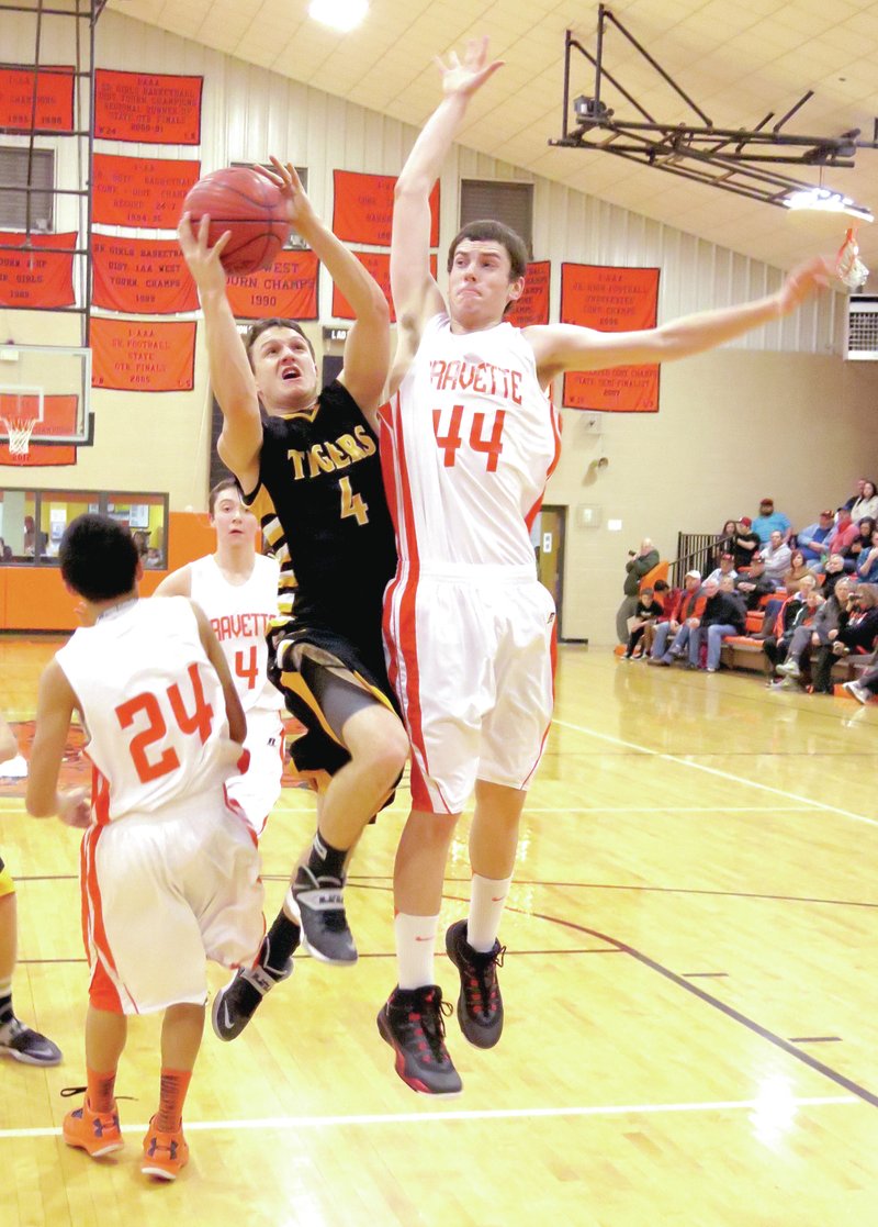 RANDY MOLL NWA MEDIA Ty Tice fearlessly drives the lane against Gravette&#8217;s 6-foot-7 Otto Troutner during the 2013-14 season. Tice is Male Athlete of the Year at Prairie Grove for 2014.