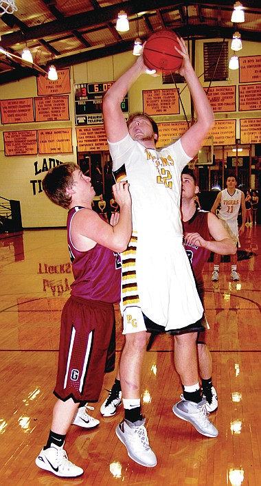 BEN MADRID ENTERPRISE-LEADER A Gentry defender finds himself with a tall order trying to prevent Prairie Grove&#8217;s 6-foot-7 Dylan Soehner from scoring. The Tigers beat the Pioneers at home 66-55 on Jan. 13.