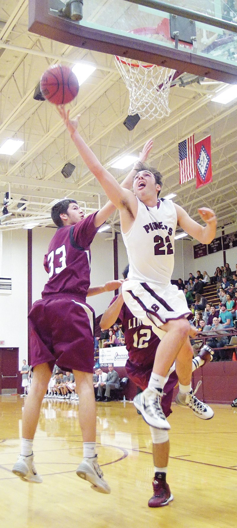 Photo by Randy Moll Brent Barker, Gentry senior, puts up a shot under the basket around Lincoln defender Shandon Goldman during play between Gentry and Lincoln on Friday night in Gentry.