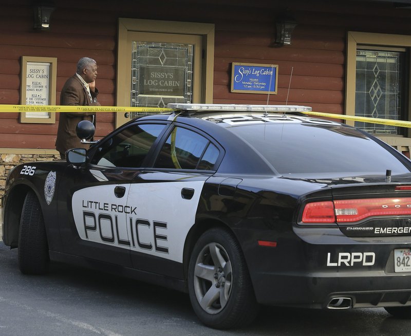 Police investigate a Wednesday afternoon robbery at Sissy's Log Cabin at 1825 N. Grant St. in Little Rock. 