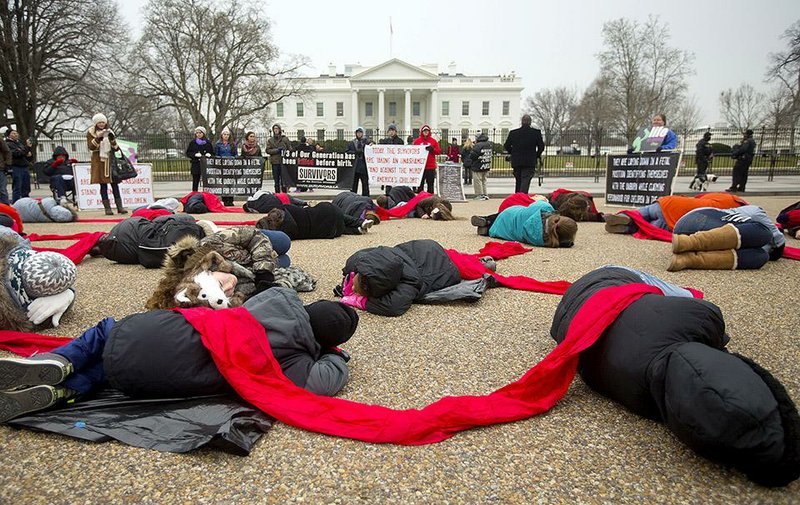 Anti-abortion activists stage a “die-in” Wednesday in front of the White House. Today marks the 42nd anniversary of the Roe v. Wade Supreme Court decision that disallowed many federal and state restrictions on abortion.