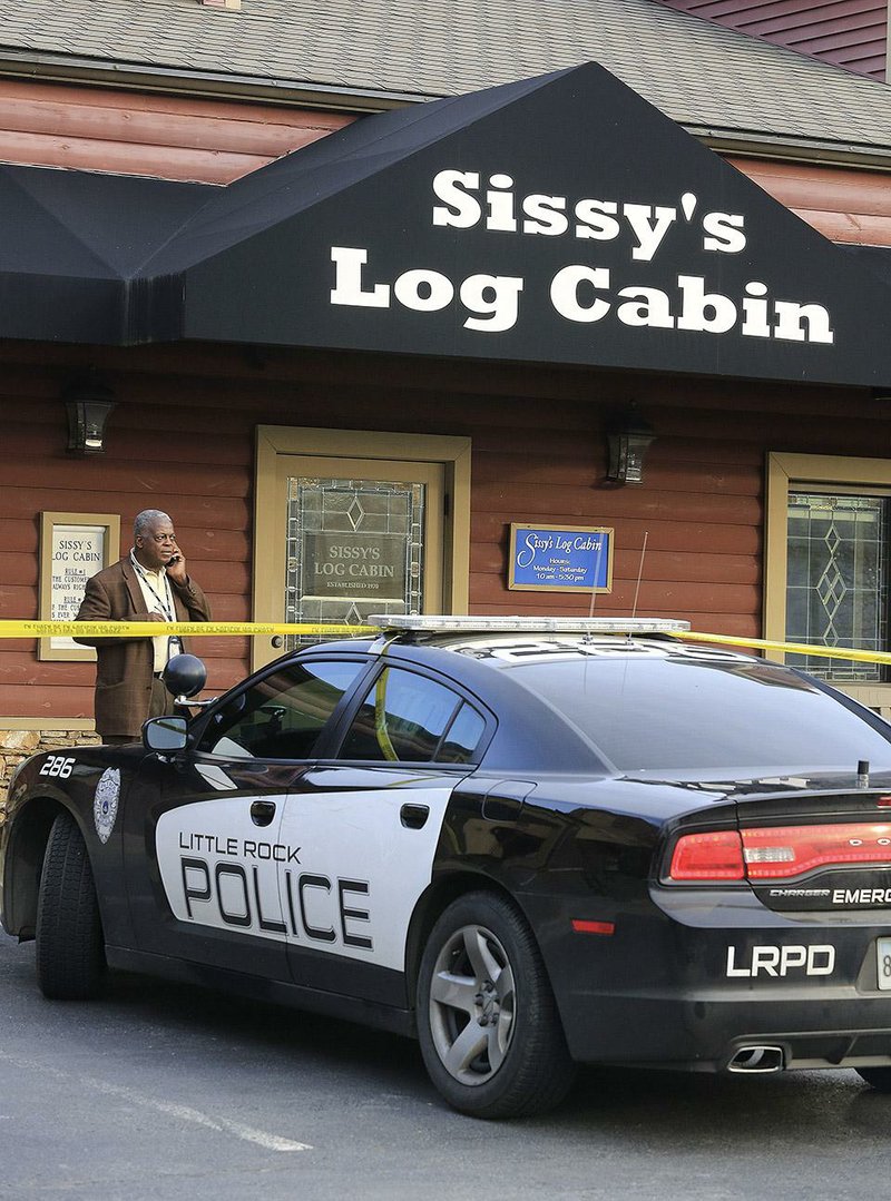 Little Rock police detective Glenn King works outside Sissy’s Log Cabin jewelry store at 1825 N. Grant St. after the store was robbed Wednesday afternoon. 