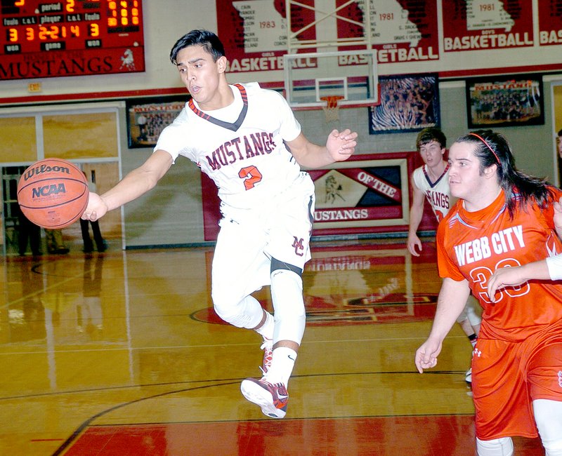RICK PECK MCDONALD COUNTY PRESS McDonald County&#8217;s Damian Monsalvo goes after a loose ball while Webb City&#8217;s Tayler Arterburn looks on during the Mustangs&#8217; 32-30 win Monday night at MCHS.