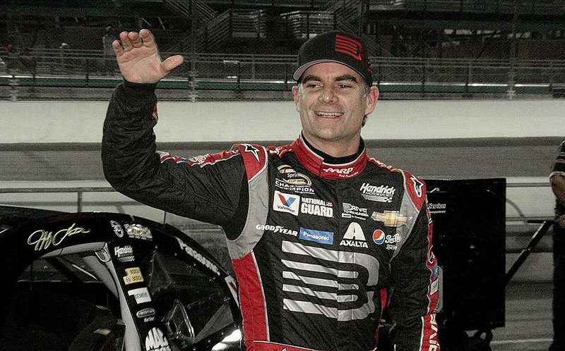 FILE - In this Nov. 14, 2014, file photo, Jeff Gordon celebrates after qualifying laps for the EcoBoost 400 auto race in Homestead, Fla. Gordon says he will retire as a full-time driver after the 2015 season. (AP Photo/Darryl Graham, File)