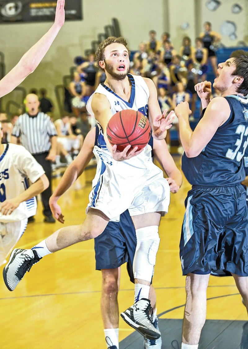  NWA Democrat-Gazette/JASON IVESTER Milacio Freeland, Rogers High junior, attempts a layup against Springdale Har-Ber on Jan. 9 at Rogers High.