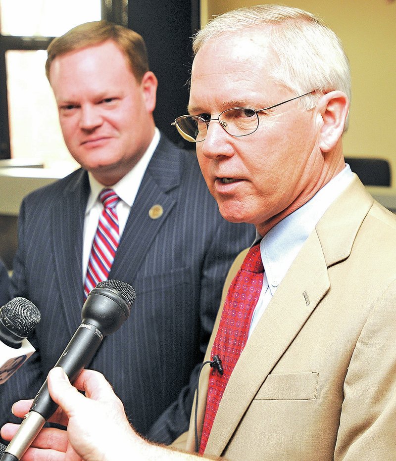 FILE PHOTO James Allen, right, answers reporters questions in March 2011 after being named the Rogers Chief of Police by Mayor Greg Hines, left, at City Hall. Allen died Wednesday after a lengthy illness.