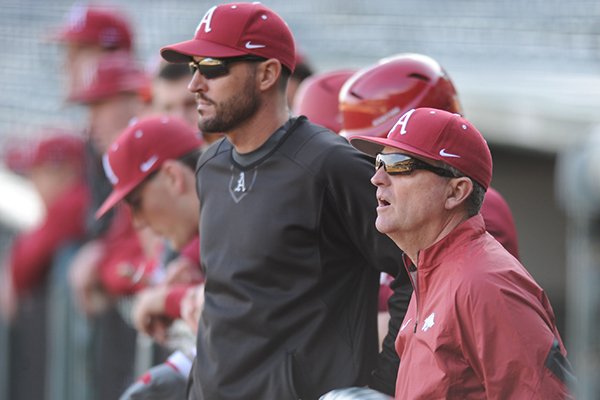 Arkansas coach Dave Van Horn watches from a dugout during practice Friday, Jan. 23, 2015, at Baum Stadium in Fayetteville.