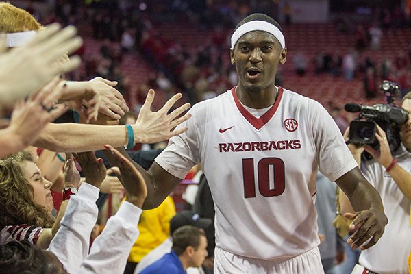 Arkansas forward Bobby Portis, right, celebrates with students after his game-winning shot in overtime of an NCAA college basketball game against Alabama on Thursday, Jan. 22, 2015, in Fayetteville, Ark. Arkansas defeated Alabama 93-91. (AP Photo/Gareth Patterson)
