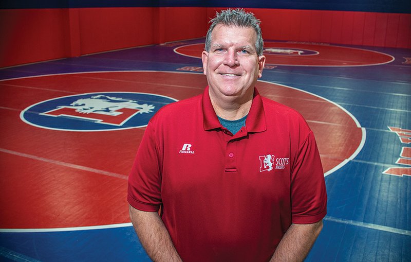 Kevin Jenkins, athletic director for Lyon College, stands on the matted area of the practice gym that has recently been finished for the wrestling program that the college now offers.