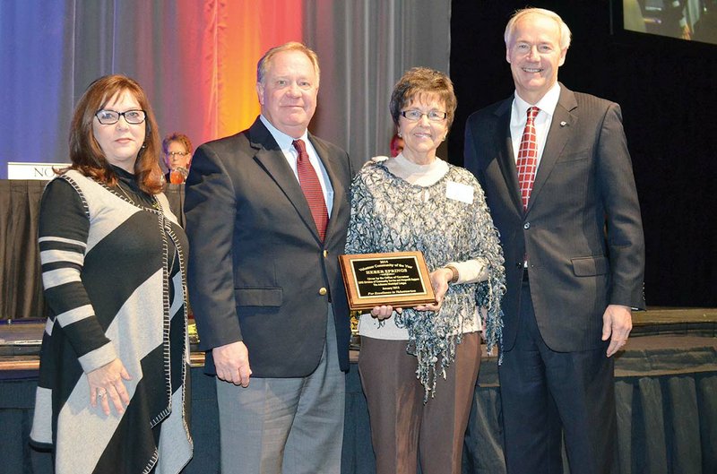 Ina Brown, second from right, special projects manager for the Heber Springs Area Chamber of Commerce, holds the 2014 Volunteer Community of the Year plaque, which was presented Jan. 15 by Gov. Asa Hutchinson, right, at a luncheon during the Arkansas Municipal League Conference at the Statehouse Convention Center in Little Rock. Also pictured are Sherry Middleton, director of the Arkansas Department of Human Services Division of Community Service and Nonprofit Support, and Heber Springs Mayor Jimmy Clark.