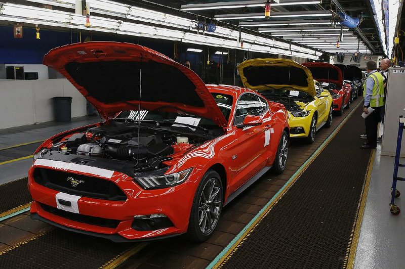 Ford Motor Co. 2015 Mustangs move along the production line at the company's Flat Rock Assembly Plant in Flat Rock, Michigan, U.S., on Thursday, Aug 28, 2014. Ford Motor Co. begins building the sixth generation of its 50-year-old Mustang sports car today at a Michigan plant that will export it to more than 120 countries. Photographer: Jeff Kowalsky/Bloomberg