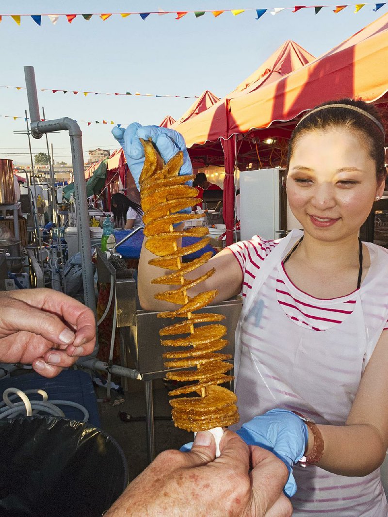 "Rotato," breaded, flavored and deep fried potatoes sliced into connected disks and served on a skewer stick. Richmond Night Market, Richmond, British Columbia, Canada.
chinatown - potato
