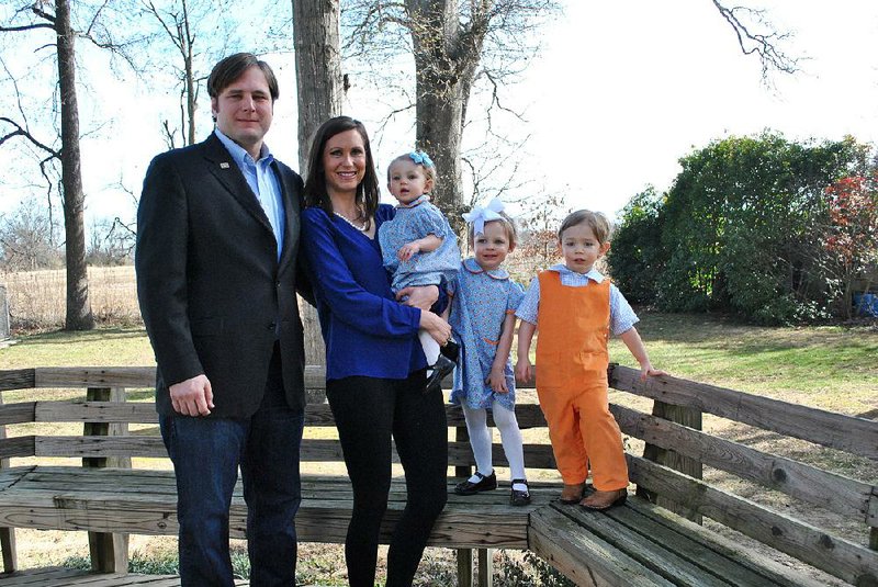 Arkansas Democrat-Gazette/BRIAN FANNEY - 01/21/2015  - Nathan and Kristin Reed stand with their three children, 1-year-old Katherine and 2-year-old twins Jane-Anne and Stanley ‚ÄúEldon,‚Äù behind their home in Marianna.