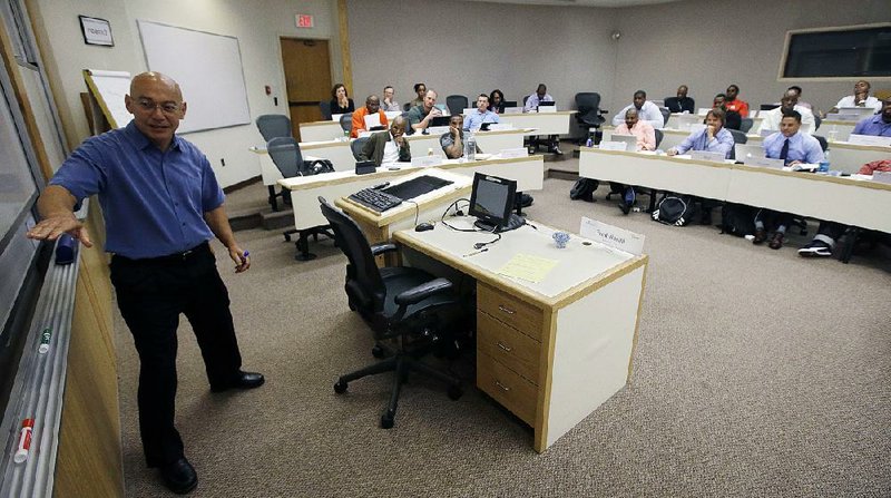 In this Tuesday, Aug. 26, 2014 photo, Fred Nanni, a professor of Management Accounting and Babson College Provost conducts a three-day business workshop for former NFL players with entrepreneurial interests, at Babson College in Wellesley, Mass. (AP Photo/Stephan Savoia)