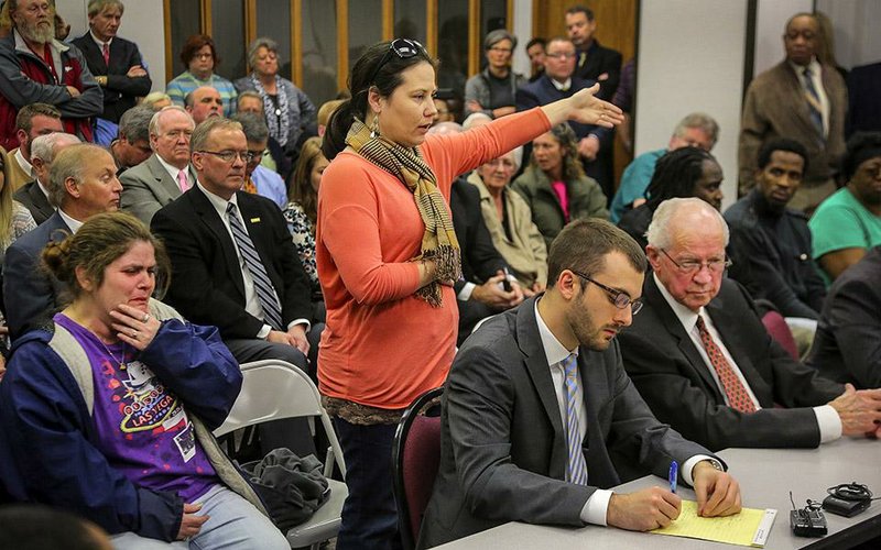 1/23/2015
Arkansas Democrat-Gazette/STEPHEN B. THORNTON
Summer Hill, bottom left, weeps as her sister- in-law Jennifer Hill, center standing, describes the maltreatment of her mother-in-law's remains by Arkansas Funeral Care during a meeting of the state Board of Embalmers and Funeral Directors Friday January 23, 2015 in Little Rock, Ark. The board voted to suspend the license of Arkansas Funeral Care's manager LeRoy Wood, bottom right, during the meeting.  When asked by a television reporter after the meeting if Wood had anything to say to the families, his only reply, which he repeated, was "Have a wonderful day."
