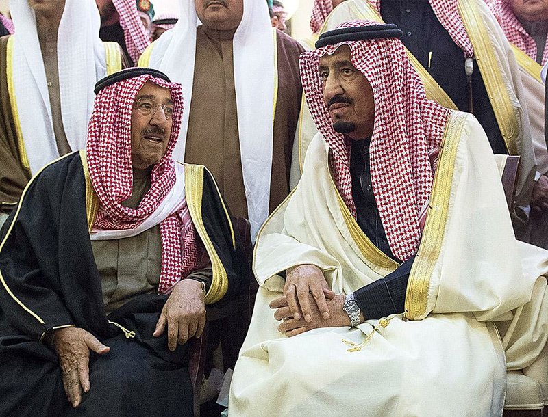 In this photo provided by the Saudi Press Agency, Saudi Arabia's newly enthroned King Salman, right, talks with Kuwait's Emir Sheikh Sabah Al-Ahmad Al-Jaber Al-Sabah during the funeral of Salman's half brother King Abdullah at the Imam Turki bin Abdullah mosque in Riyadh, Saudi Arabia, Friday, Jan. 23, 2015. Saudi state TV reported early Friday that King Abdullah died at the age of 90. (AP Photo/SPA)