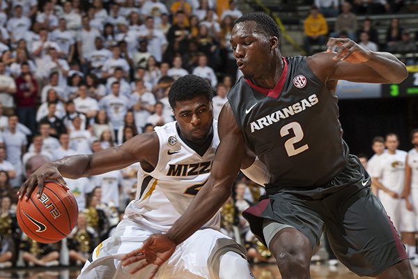 Missouri's Tramaine Isabell, left, tries to dribble around Arkansas' Alandise Harris, right, during the first half of an NCAA college basketball game Saturday, Jan. 24, 2015, in Columbia, Mo. (AP Photo/L.G. Patterson)