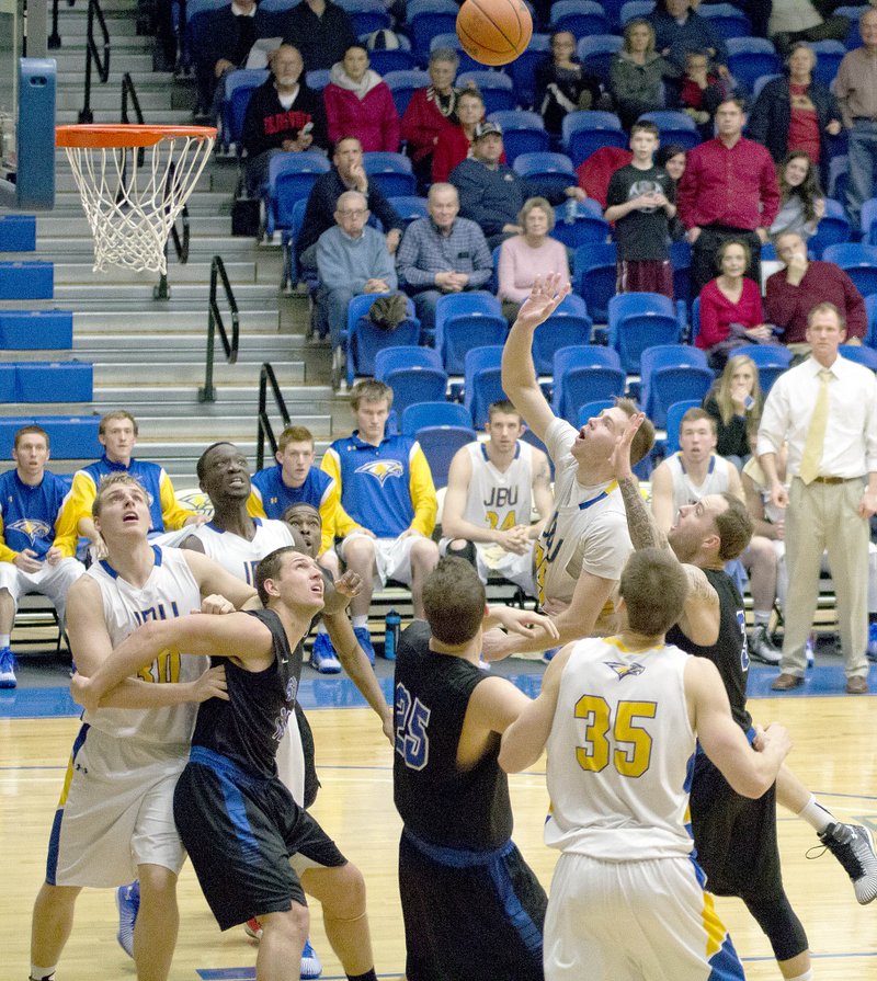 Nathan Marquardt/JBU Sports Information John Brown University junior forward Griffin Brady goes up for what would be the game-winning points in the Golden Eagles&#8217; 70-69 win Thursday against Southwestern Christian at Bill George Arena.