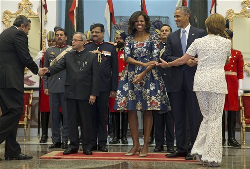 US President Barack Obama, second right, and first lady Michelle Obama react as House Minority Leader Nancy Pelosi of Calif., right, goes through the receiving line with Indian President Pranab Mukherjee, second from left, before a State Dinner at the Rashtrapati Bhavan, the presidential palace, in New Delhi, India, Sunday, Jan. 25, 2015. Obama's arrival Sunday morning in the bustling capital of New Delhi marked the first time an American leader has visited India twice during his presidency. Obama is also the first to be invited to attend India's Republic Day festivities, which commence Monday and mark the anniversary of the enactment of the country's democratic constitution. (AP Photo/Carolyn Kaster)